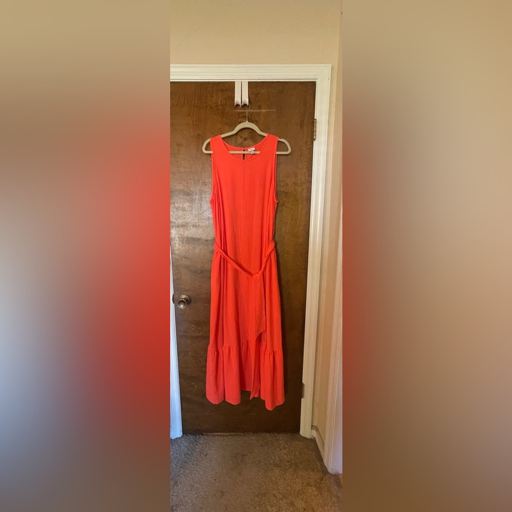Coral, sleeveless dress with fabric belt.